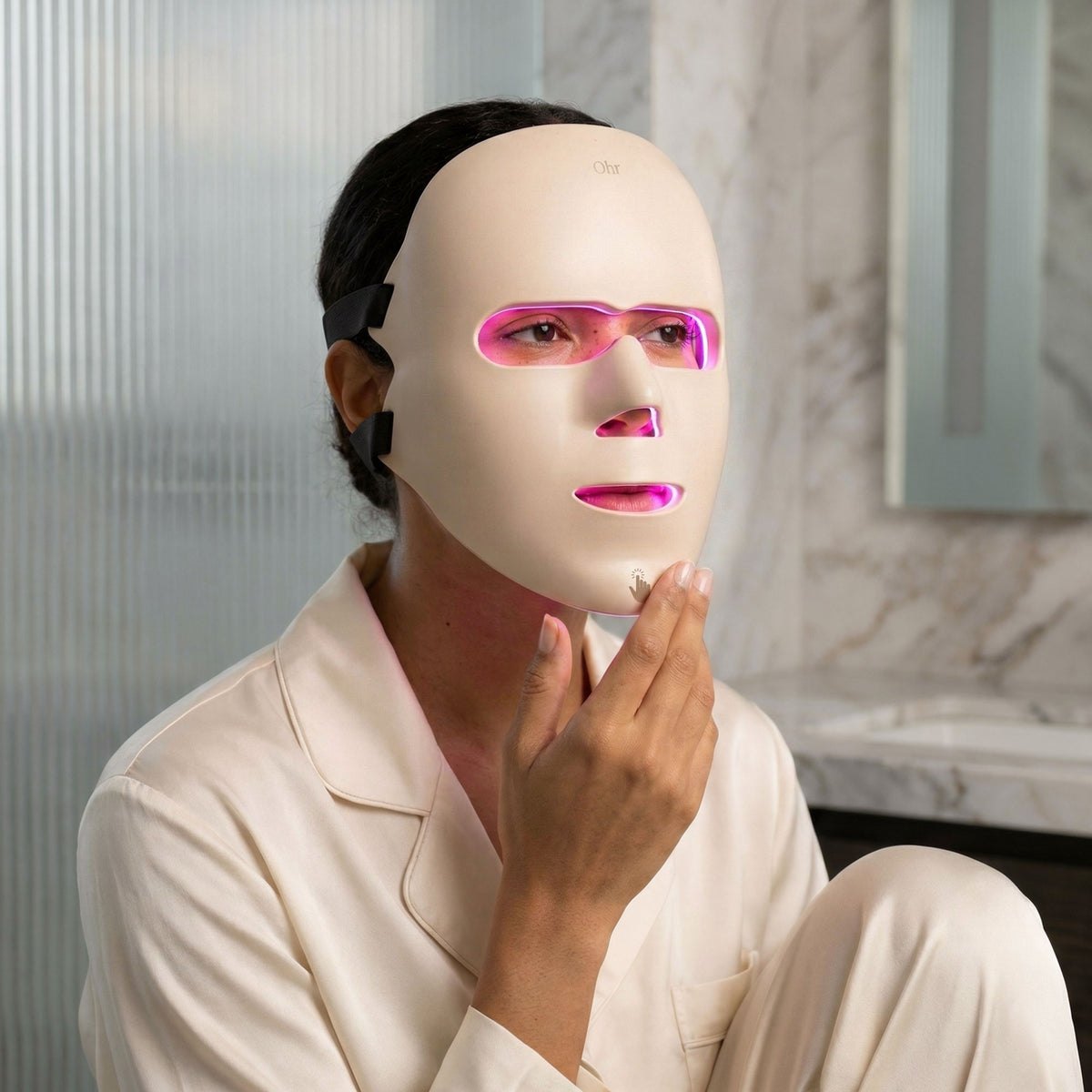 Woman wearing the LED mask glowing pink